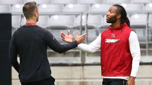 Arizona Cardinals head coach Kliff Kingsbury greets Larry Fitzgerald during the conditioning test at training camp on July 24, 2019 in Glendale, Ariz.
